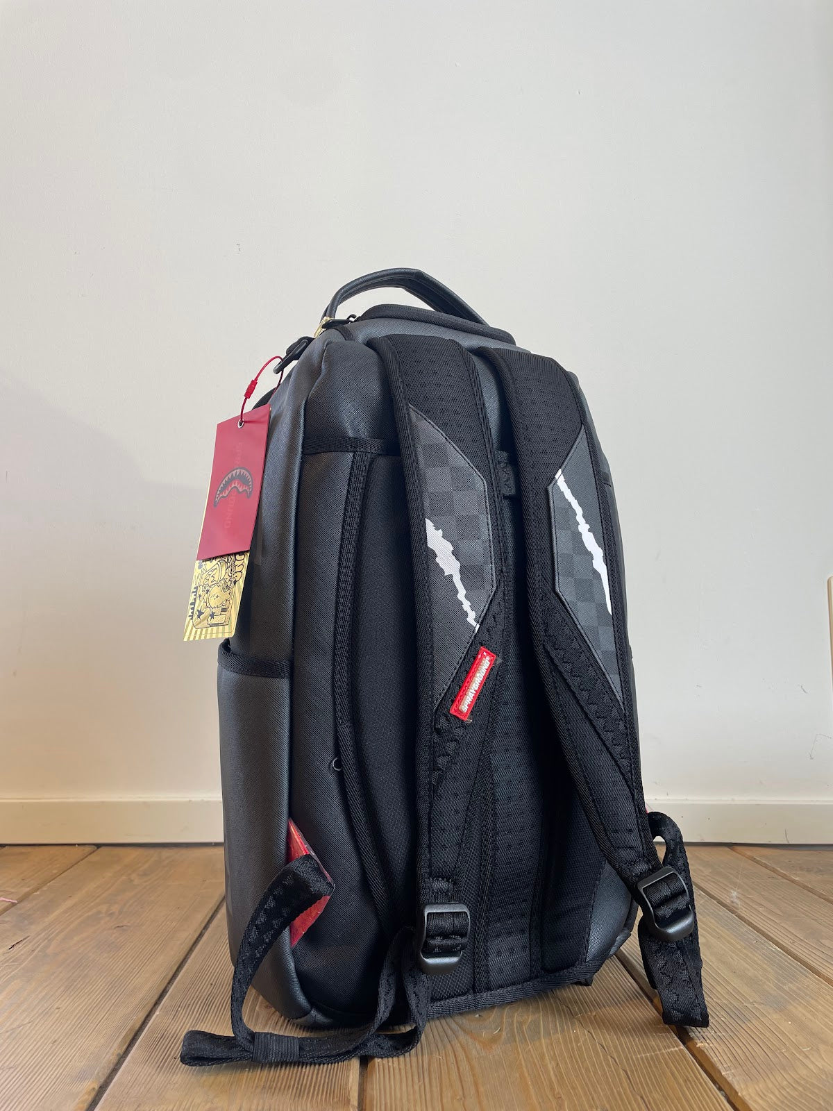 Center Rip Revealing Gray Check Backpack